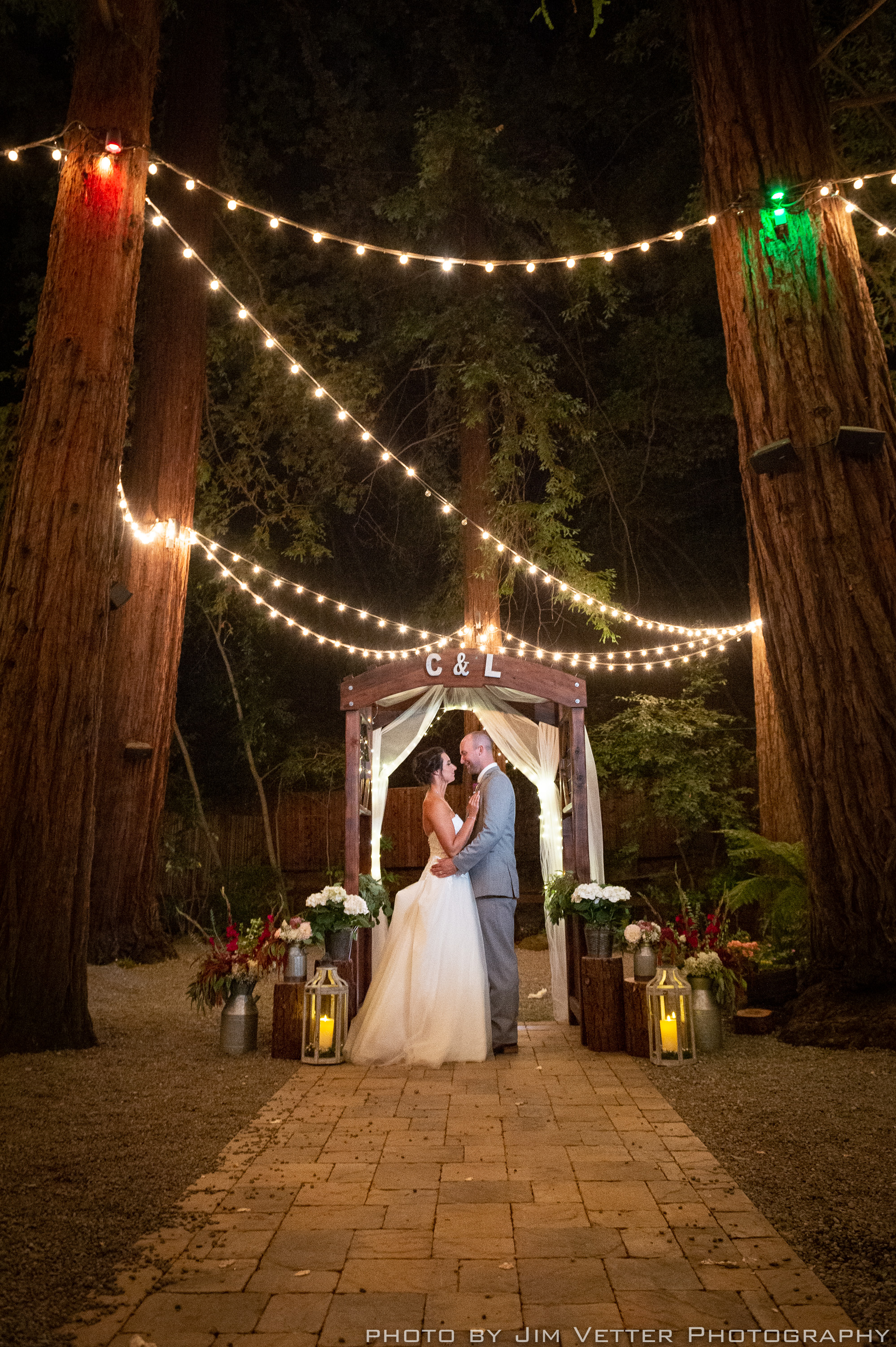 bride and groom along under redwoods at night at deer park villa