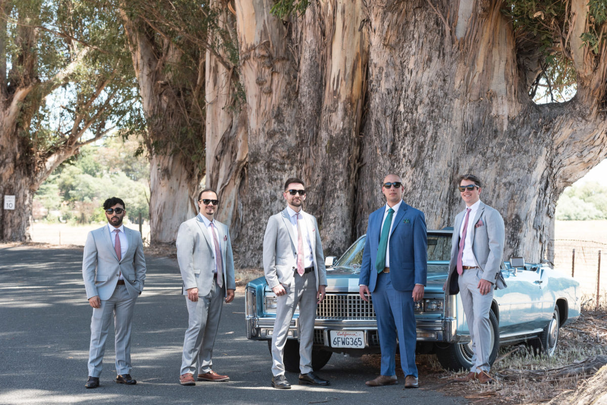 groomsmen with convertible cadillac