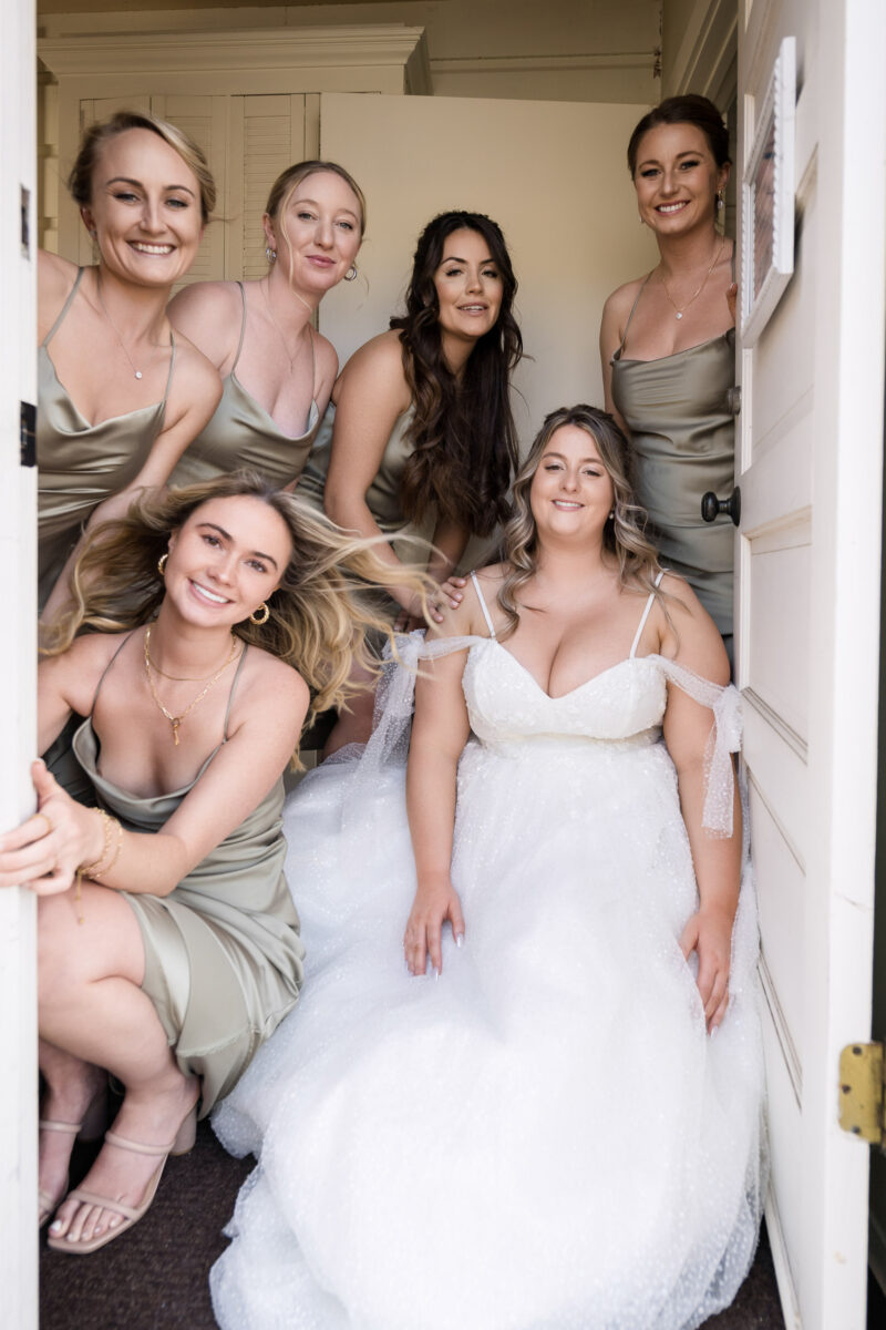 a bride and her bridesmaids posing for a picture.