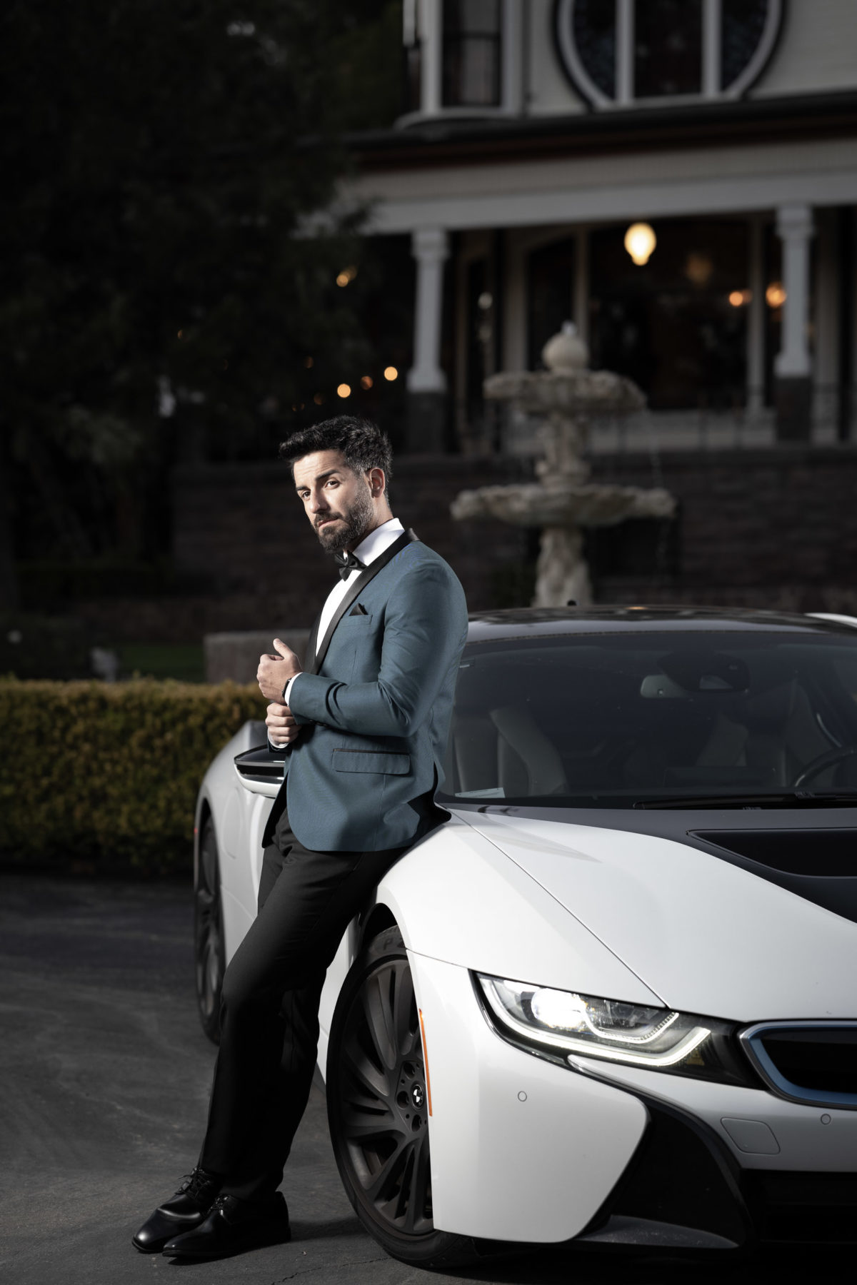 groom alone with sports car dramatic portrait