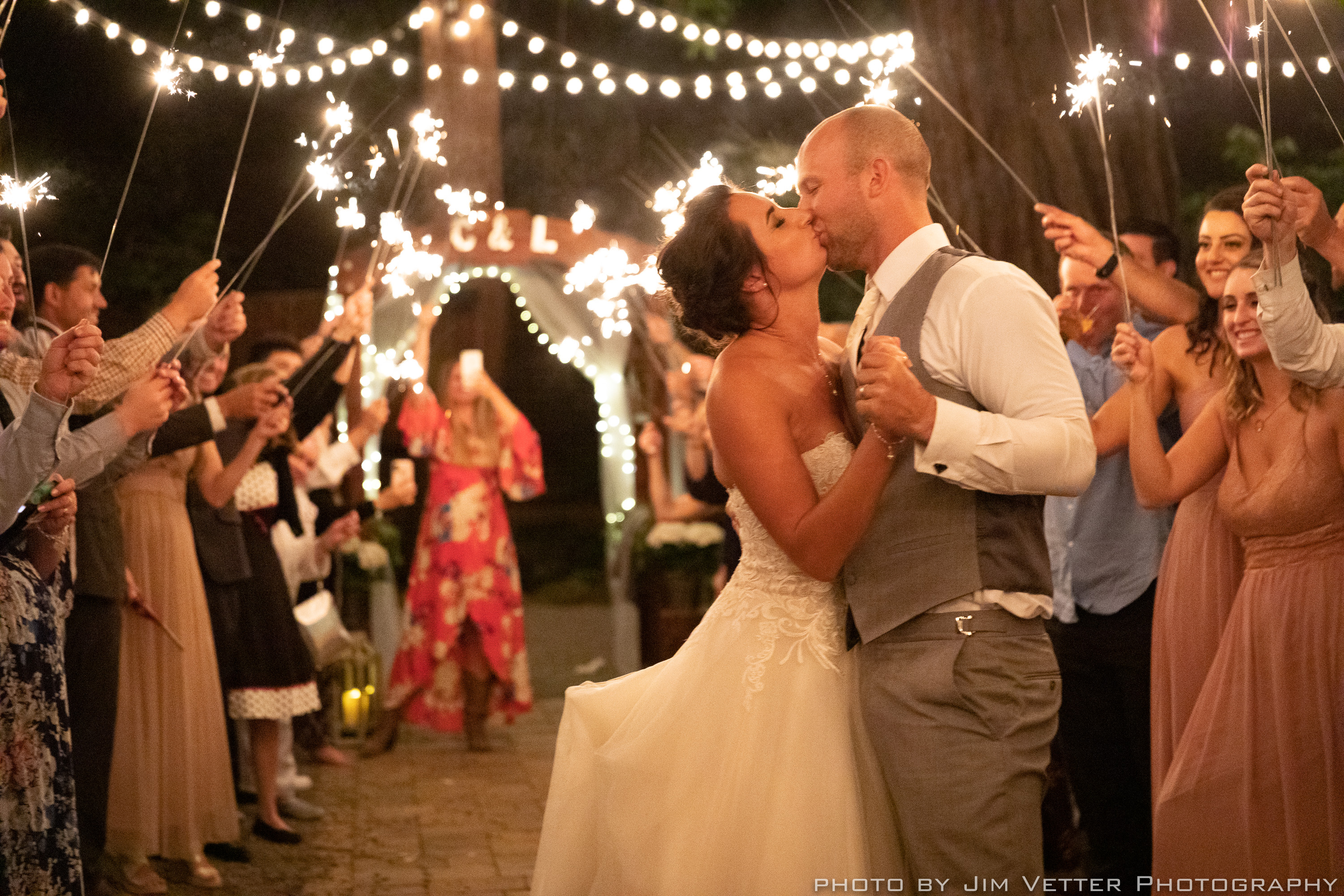 bride and groom kissing at sparkler exit deer park villa