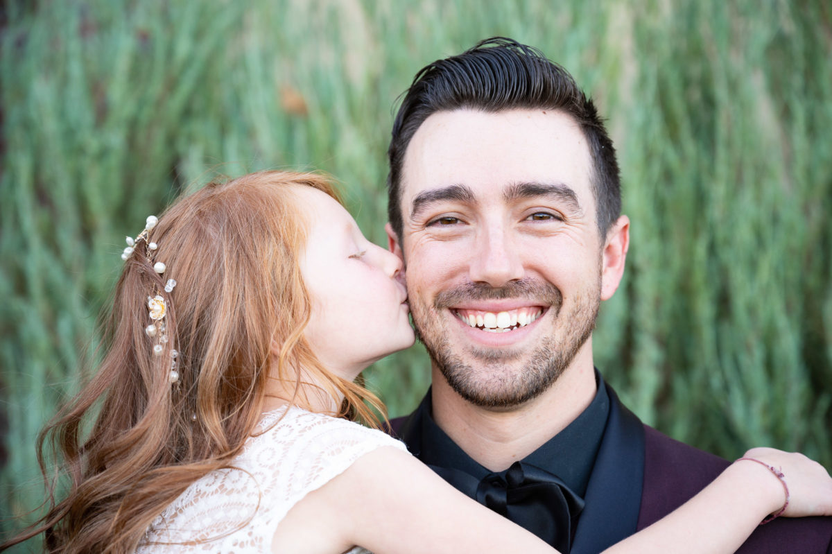 flower girl kissing groom