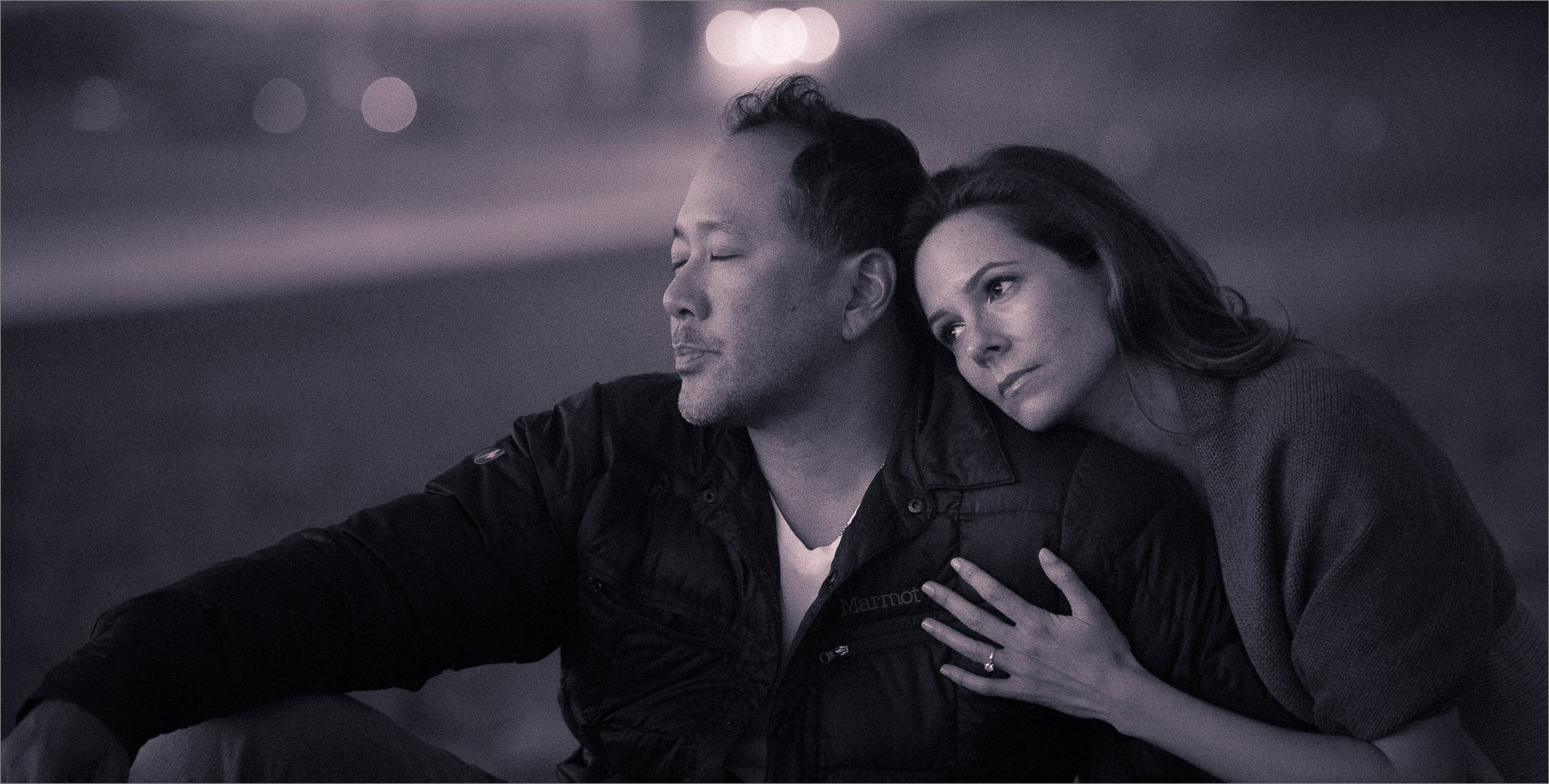 Engagement photo of man and woman on the beach in black and white