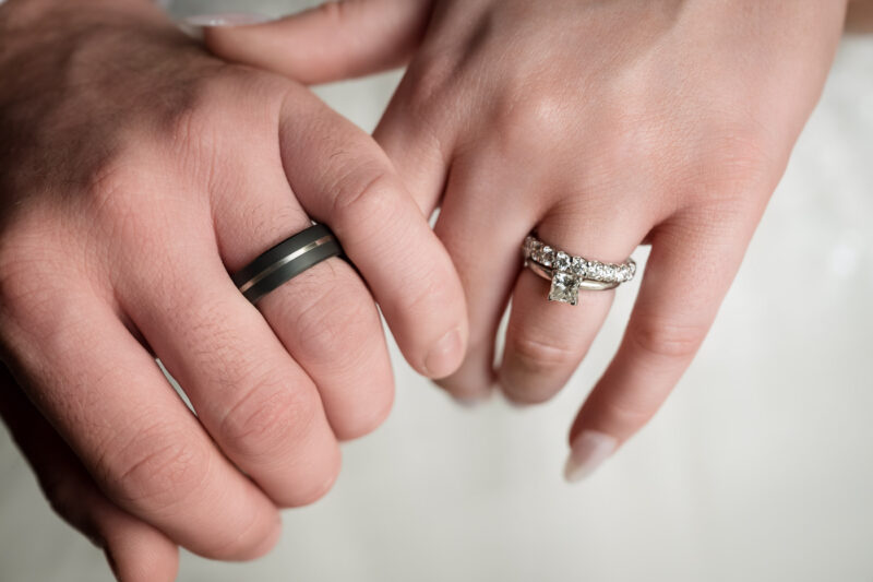 a close up of two people holding hands.