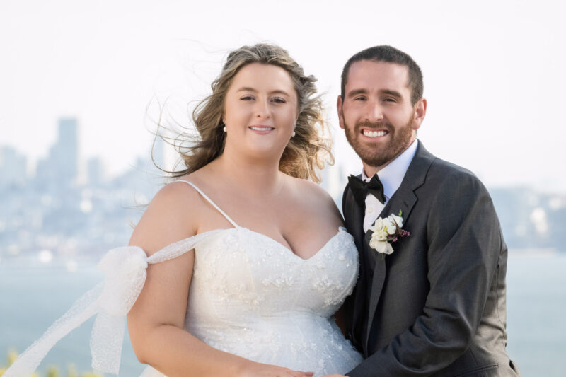 a bride and groom posing for a picture.