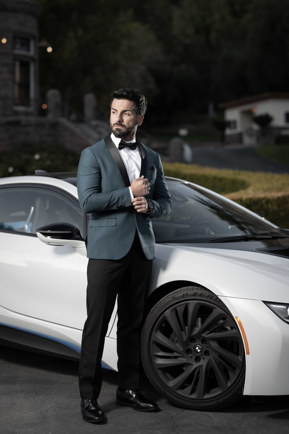 groom alone with sports car dramatic portrait