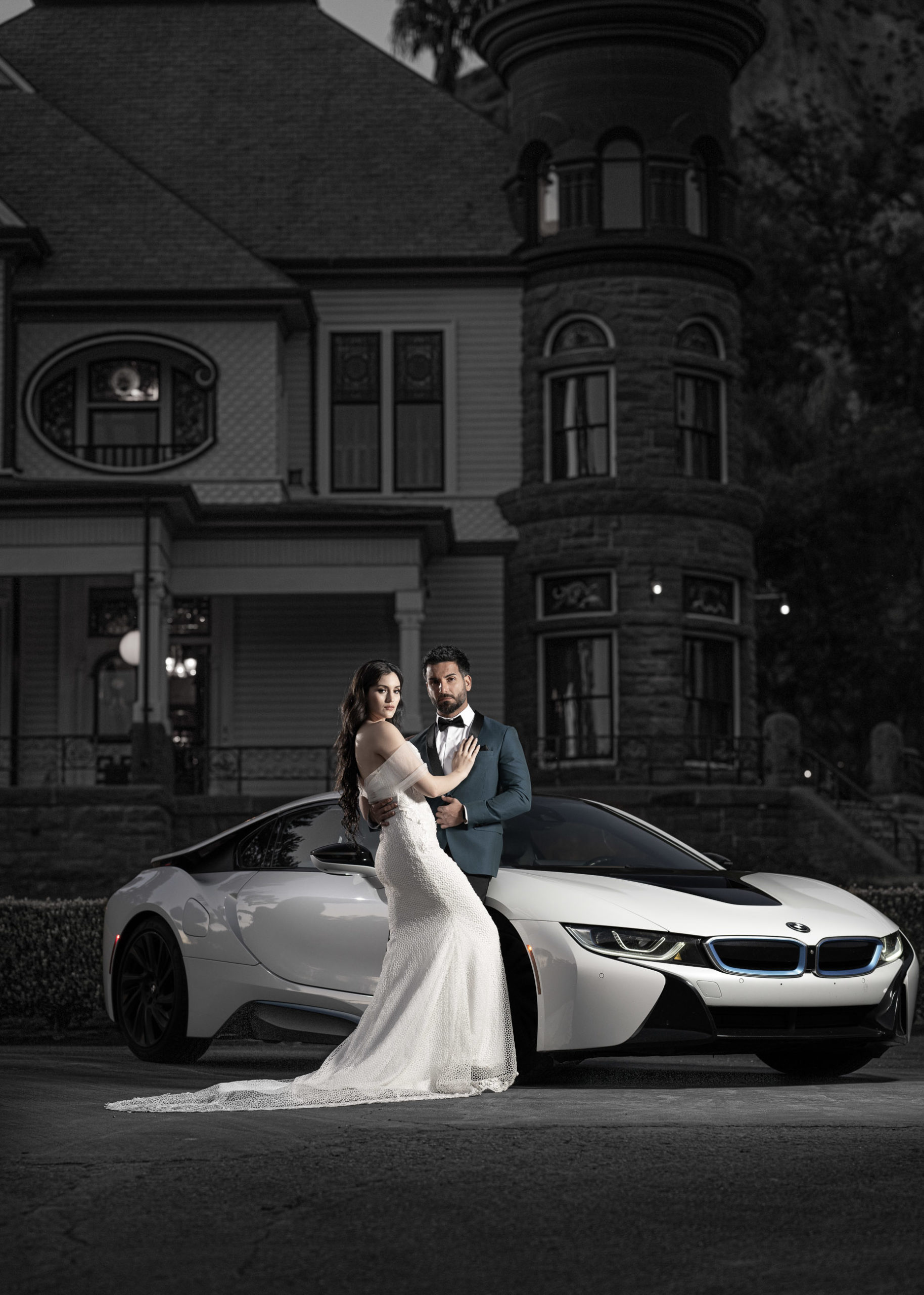 bride and groom with sports car dramatic portrait