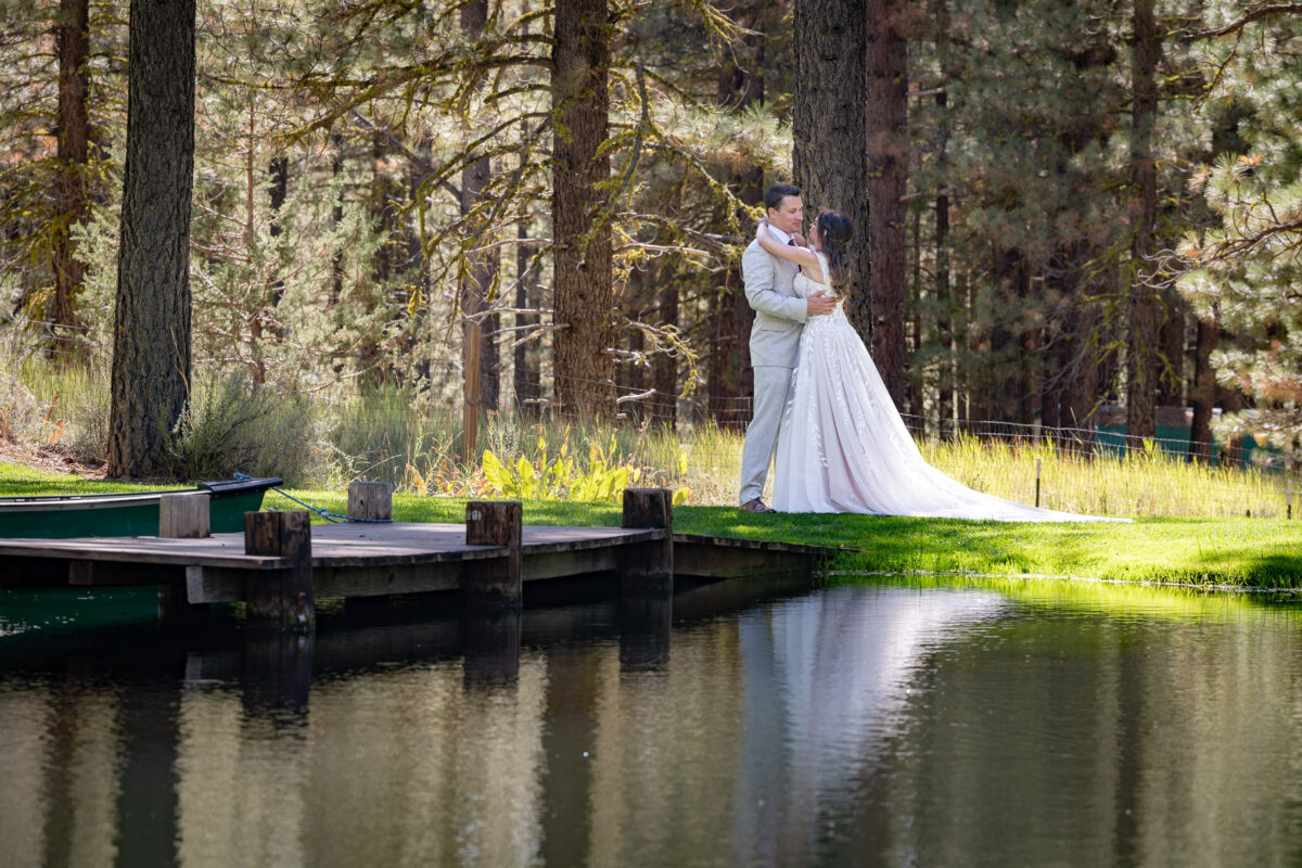 bride and groom portrait on lake dock