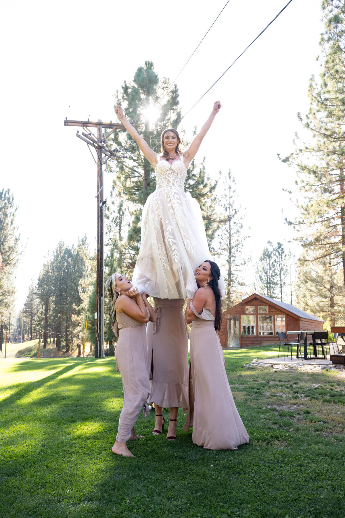 bride on shoulders of bridesmaids
