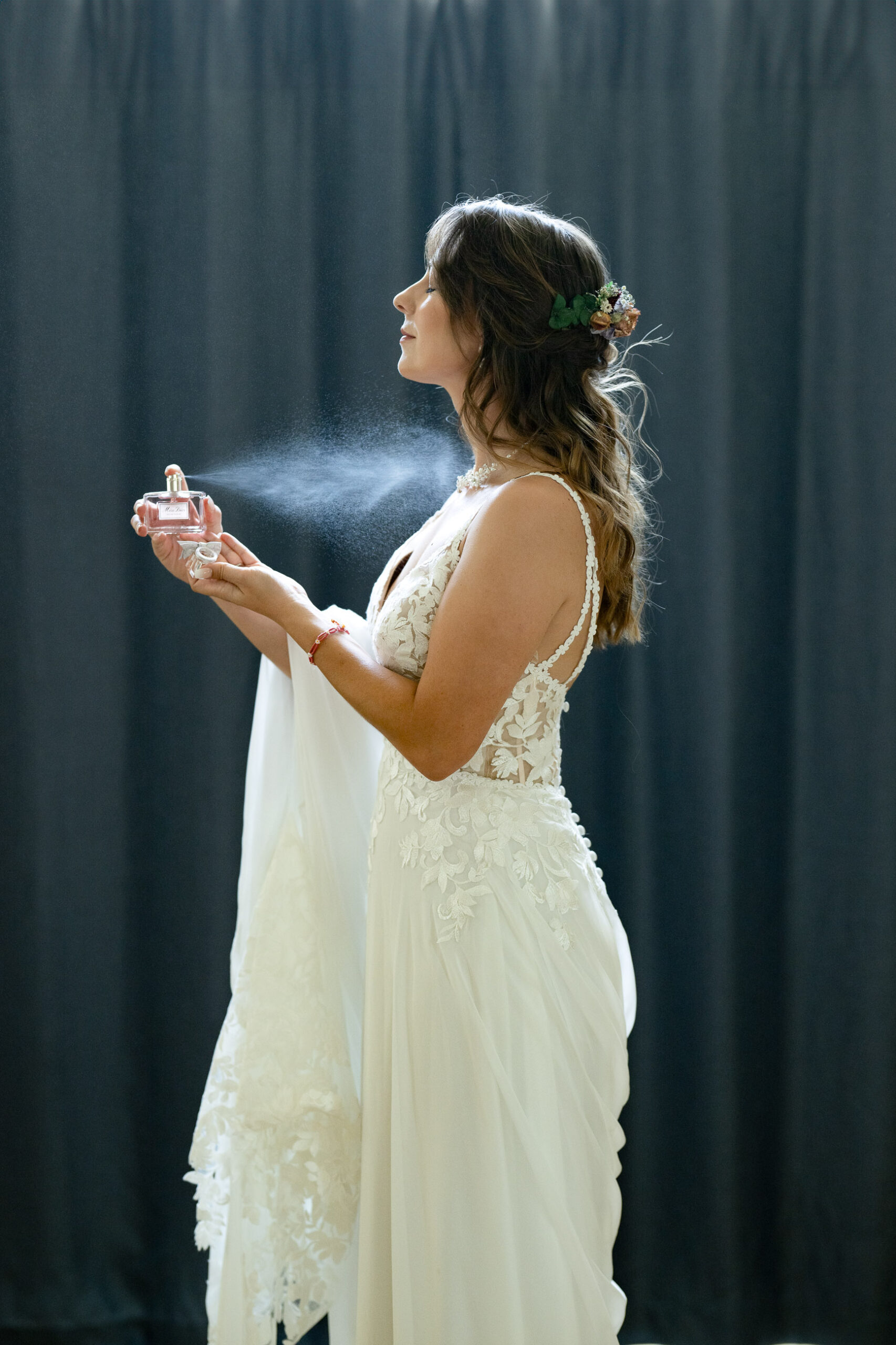 bride spraying perfume mist
