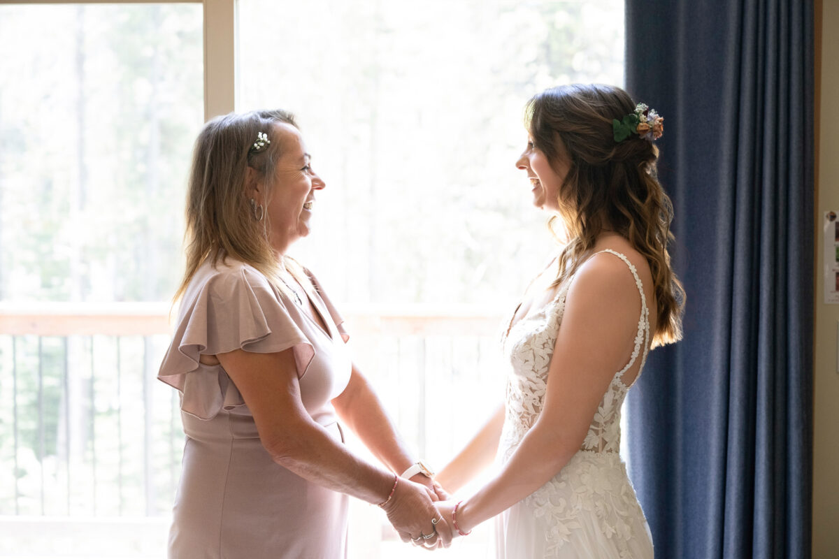 bride and mother holding hands