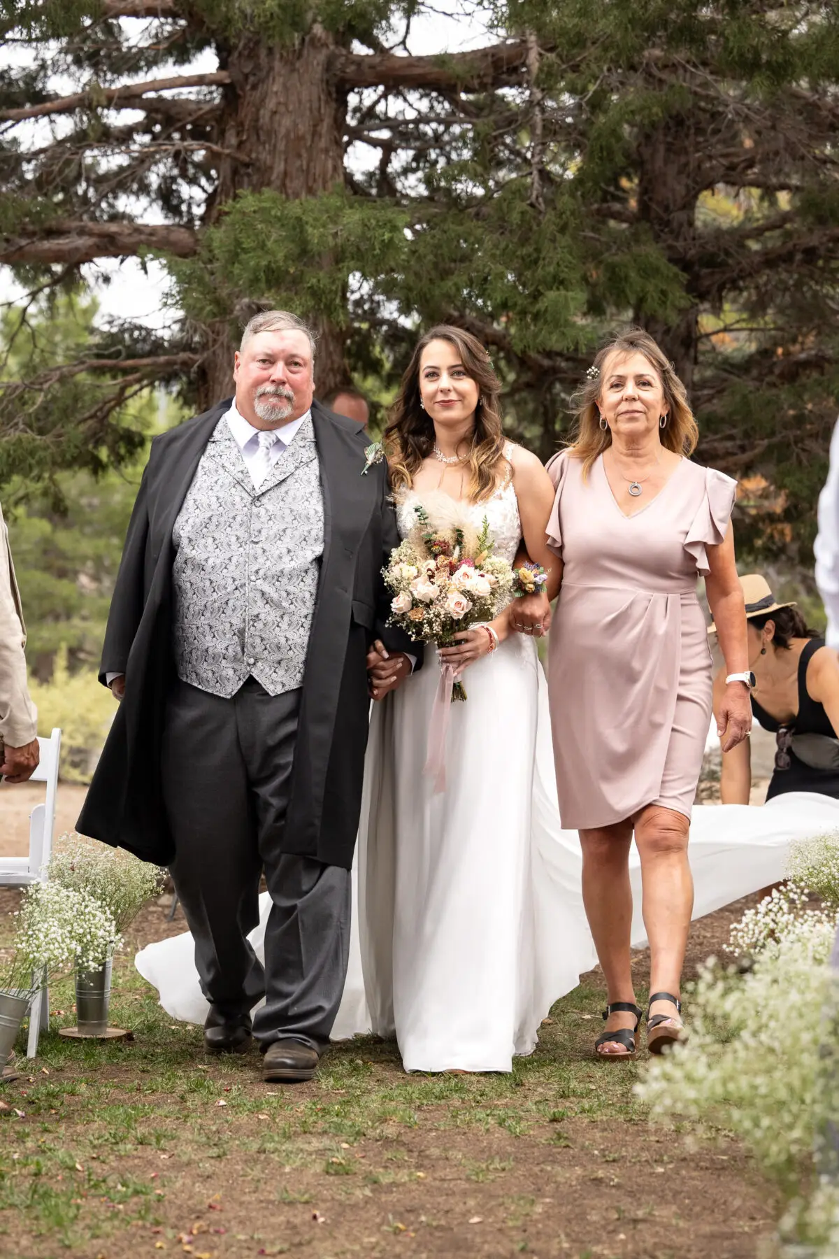 bride coming down aisle with parents