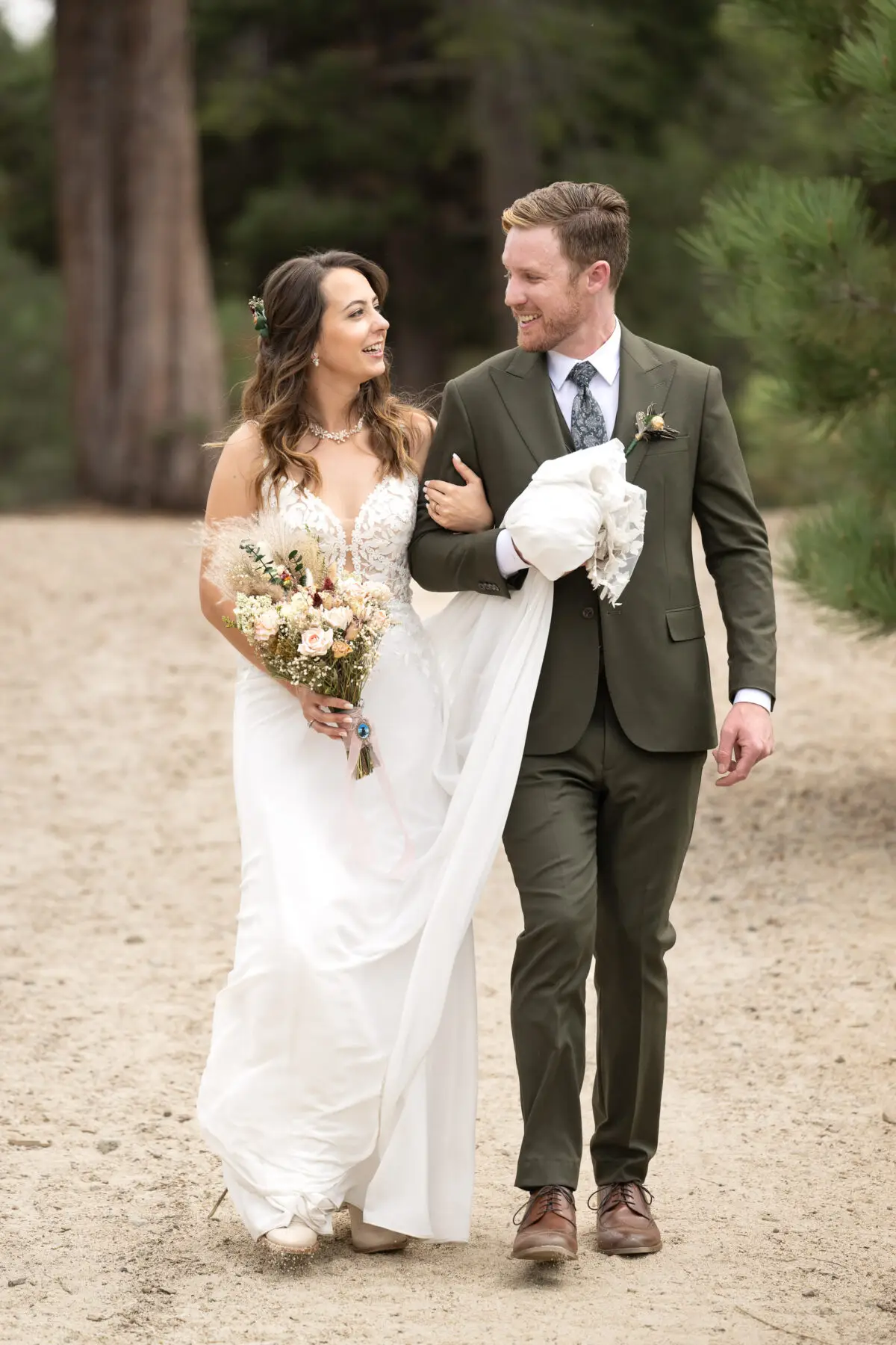 Bride and Groom walking on path in woods