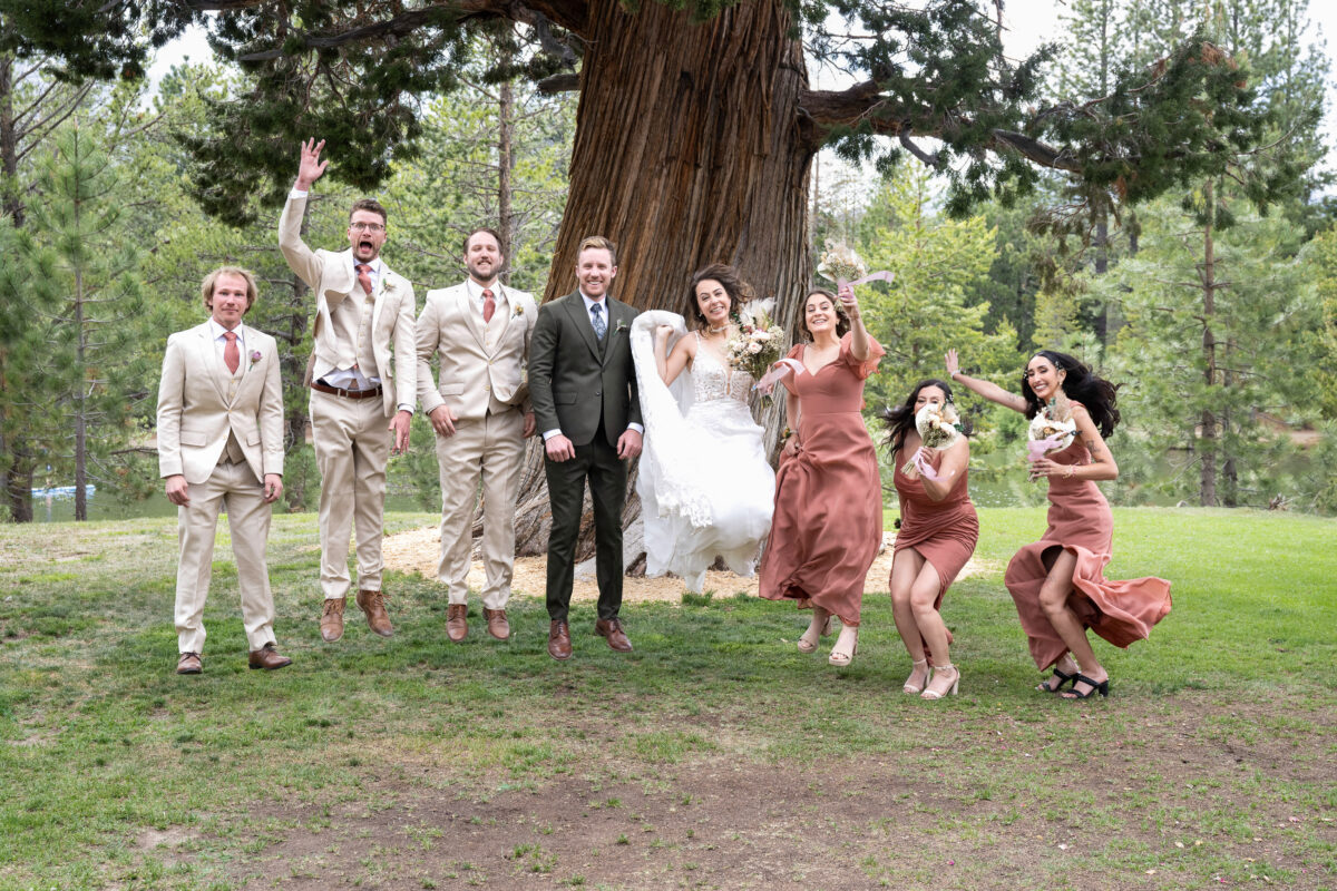 Bride and Groom with wedding party portrait jumping